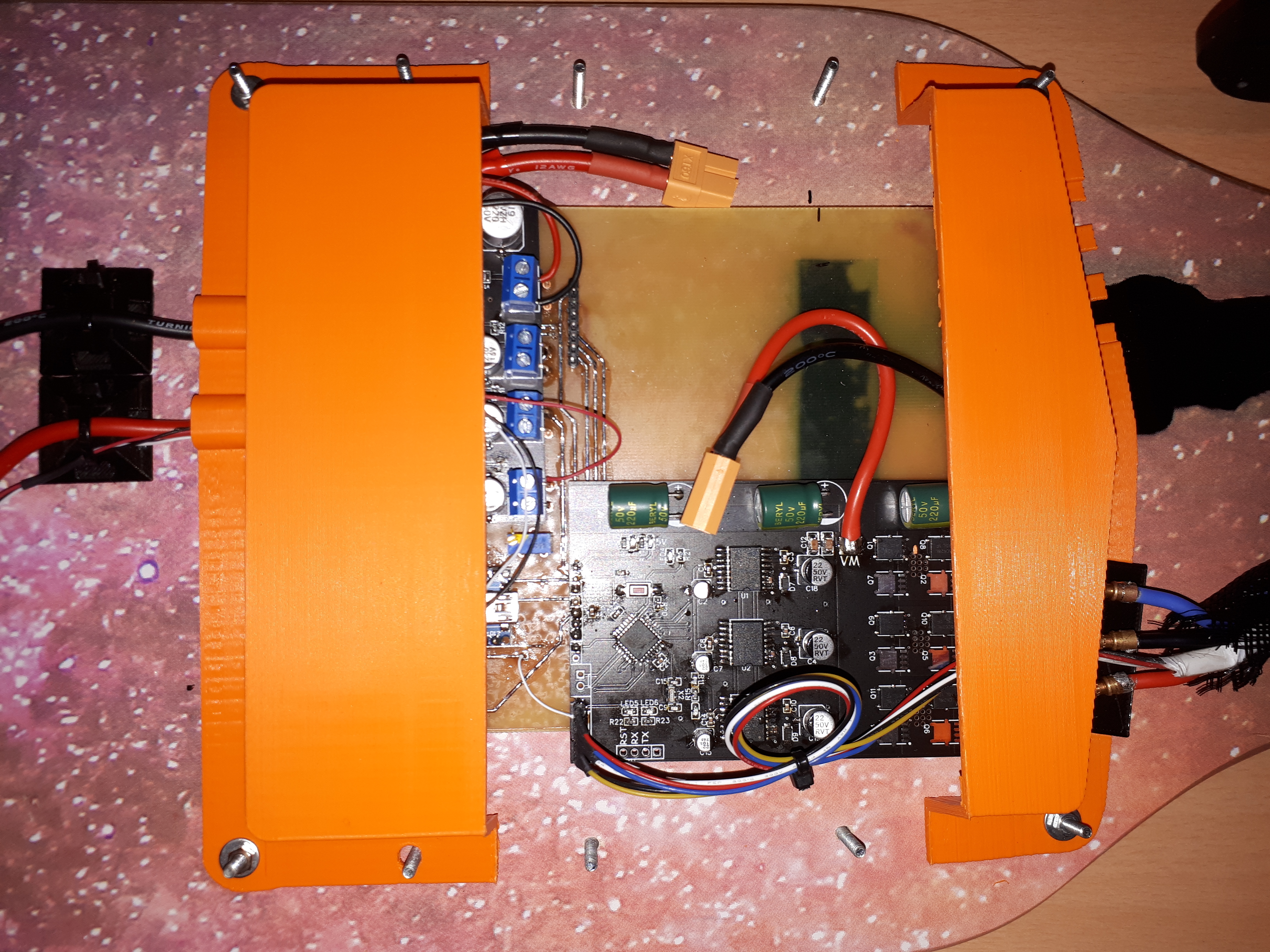 The buck converter and ESC mounted inside an enclosure